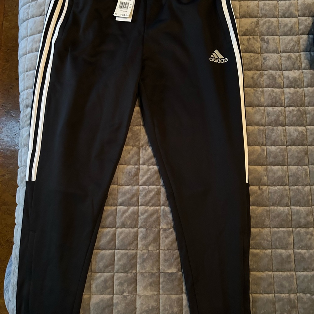Adidas Black Sweatpants with Tapered Leg and Iconic Stripes
A10